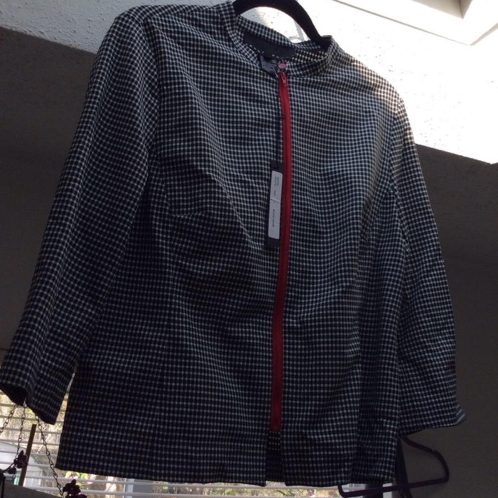 Woman Yansi Fugel plaid black and white blazer.